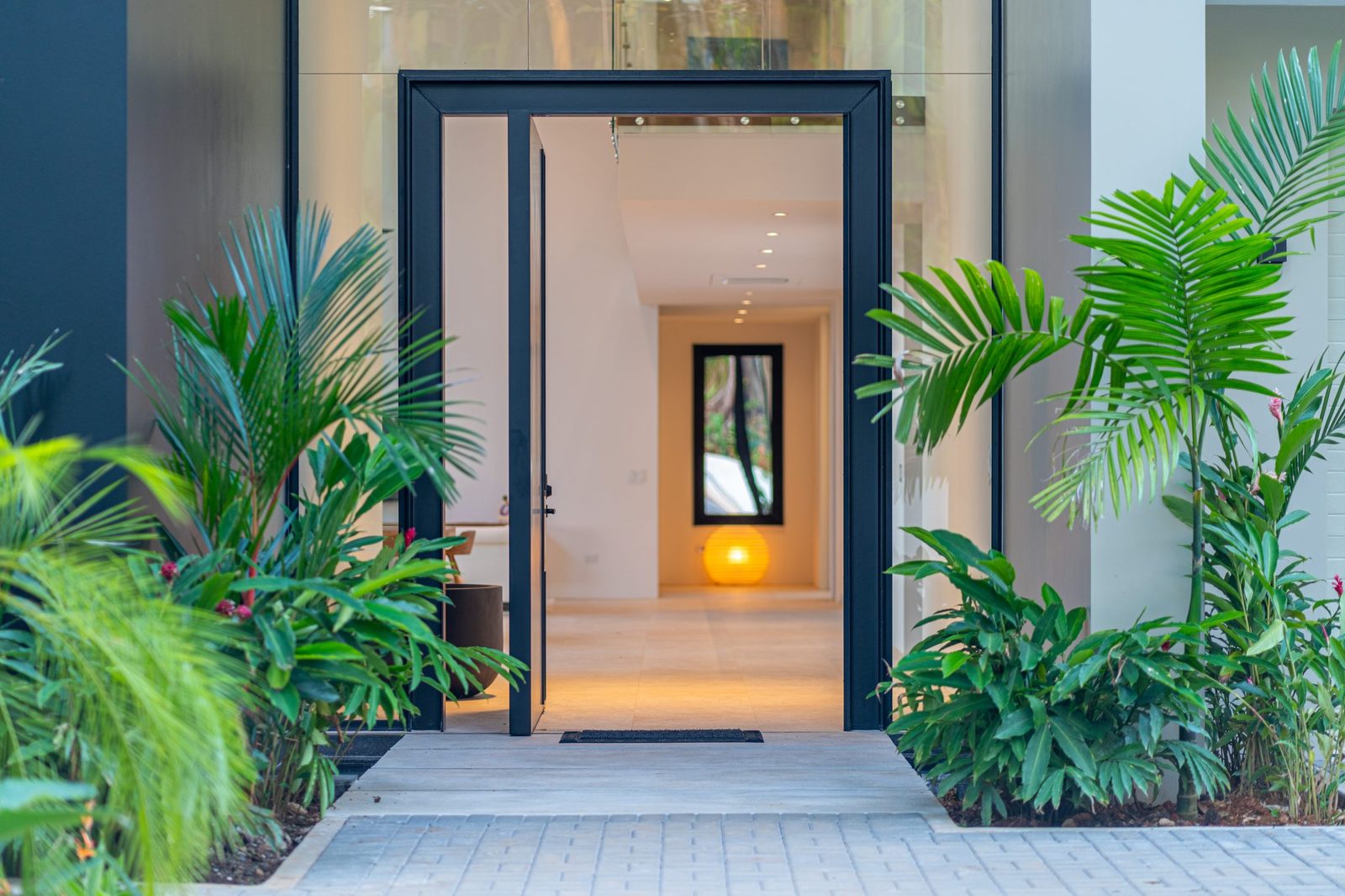 The villa entrance framed by tropical planting